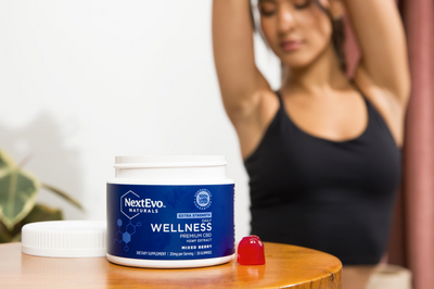 NextEvo Naturals Wellness CBD Gummies in foreground in front of woman stretching